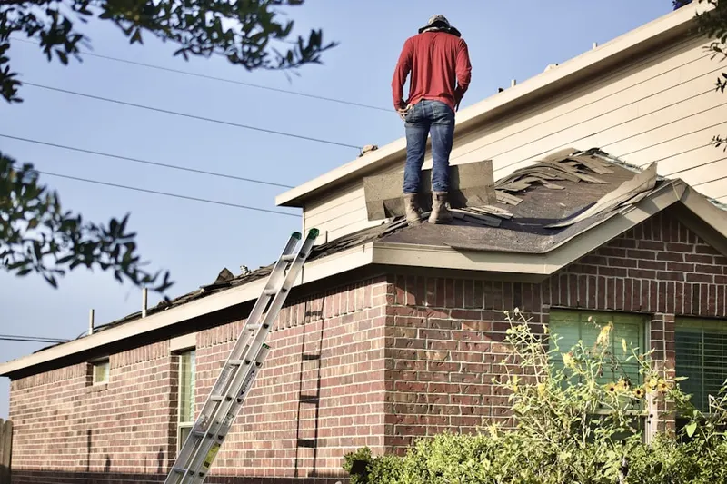 Professional roofer working on a residential roof in Bass Lake